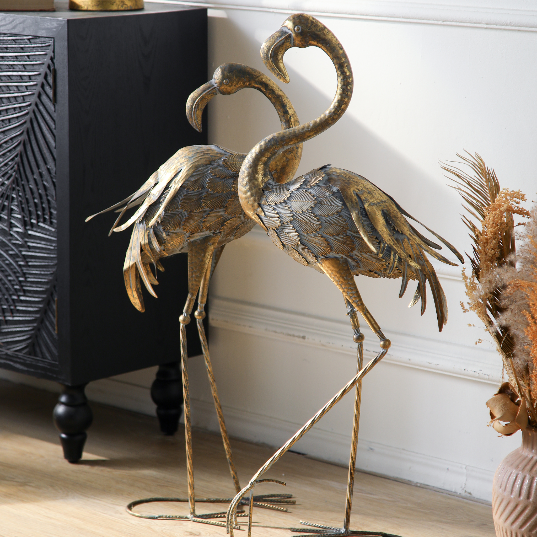 Pair of antique gold metal flamingo sculptures showing the curved S-neck silhouette