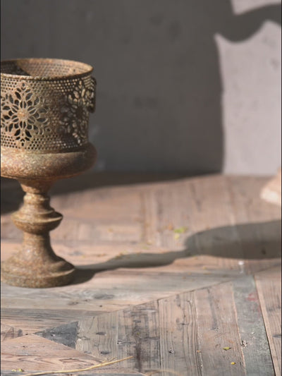 Video styling a fern into the Arthur pierced pedestal planter, the taller size, shown with the smaller size alongside