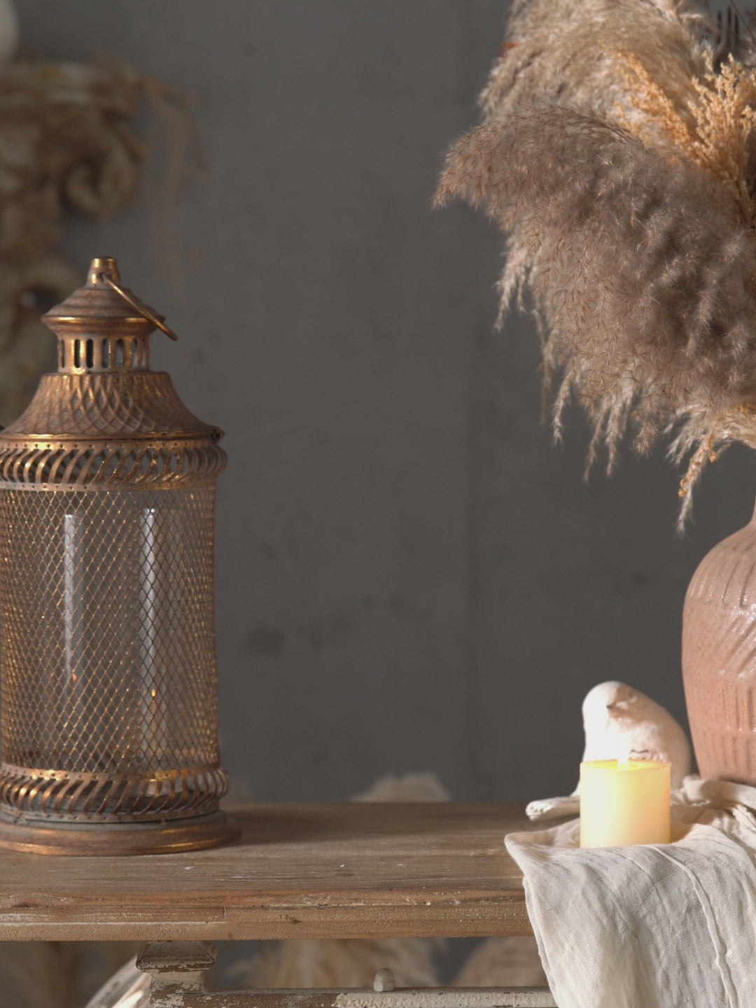 Antique gold mesh lantern glowing in a styled French provincial setting