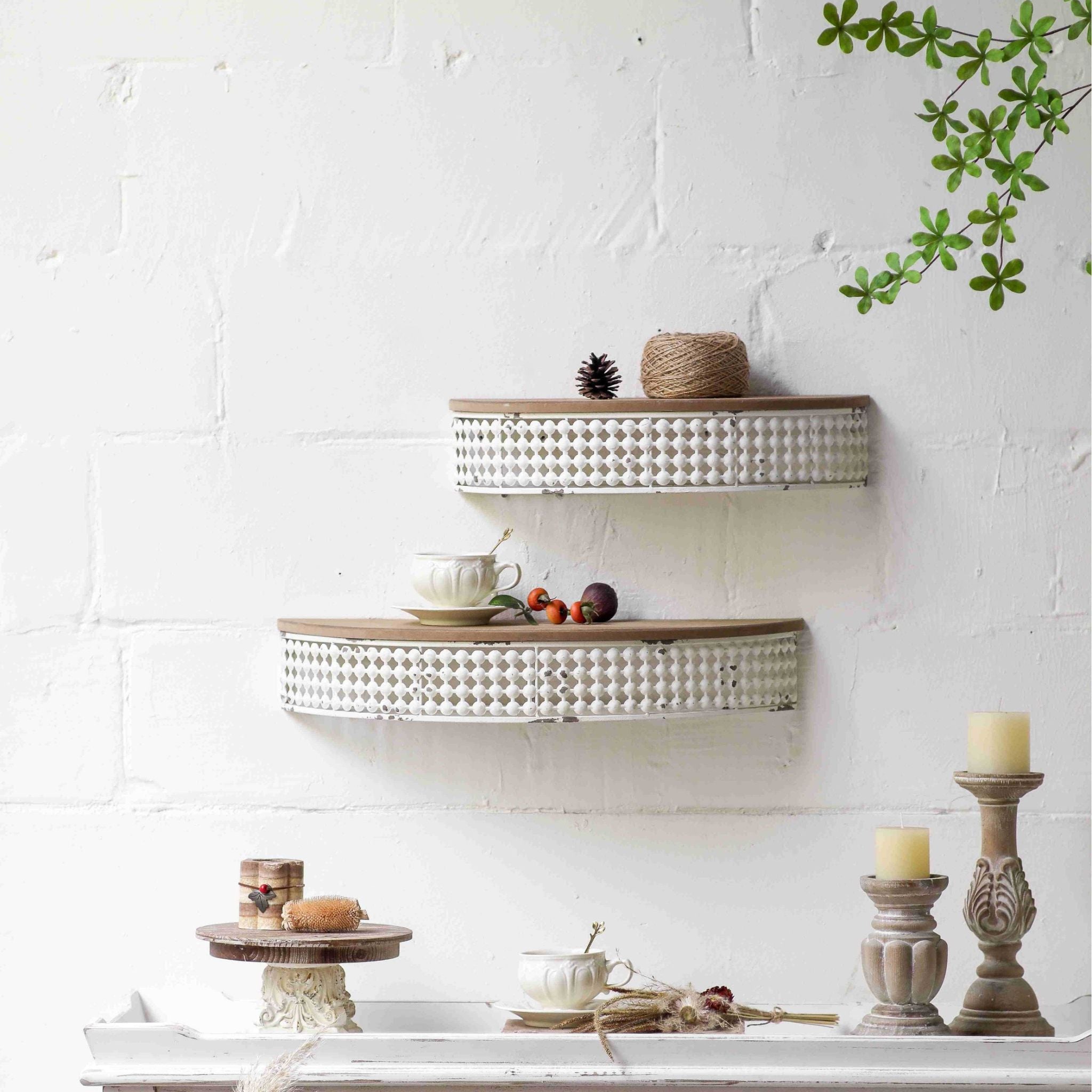 Rolande half moon wall shelf shown on a brick wall as the lower shelf, with the smaller Rita size above. Sold separately.