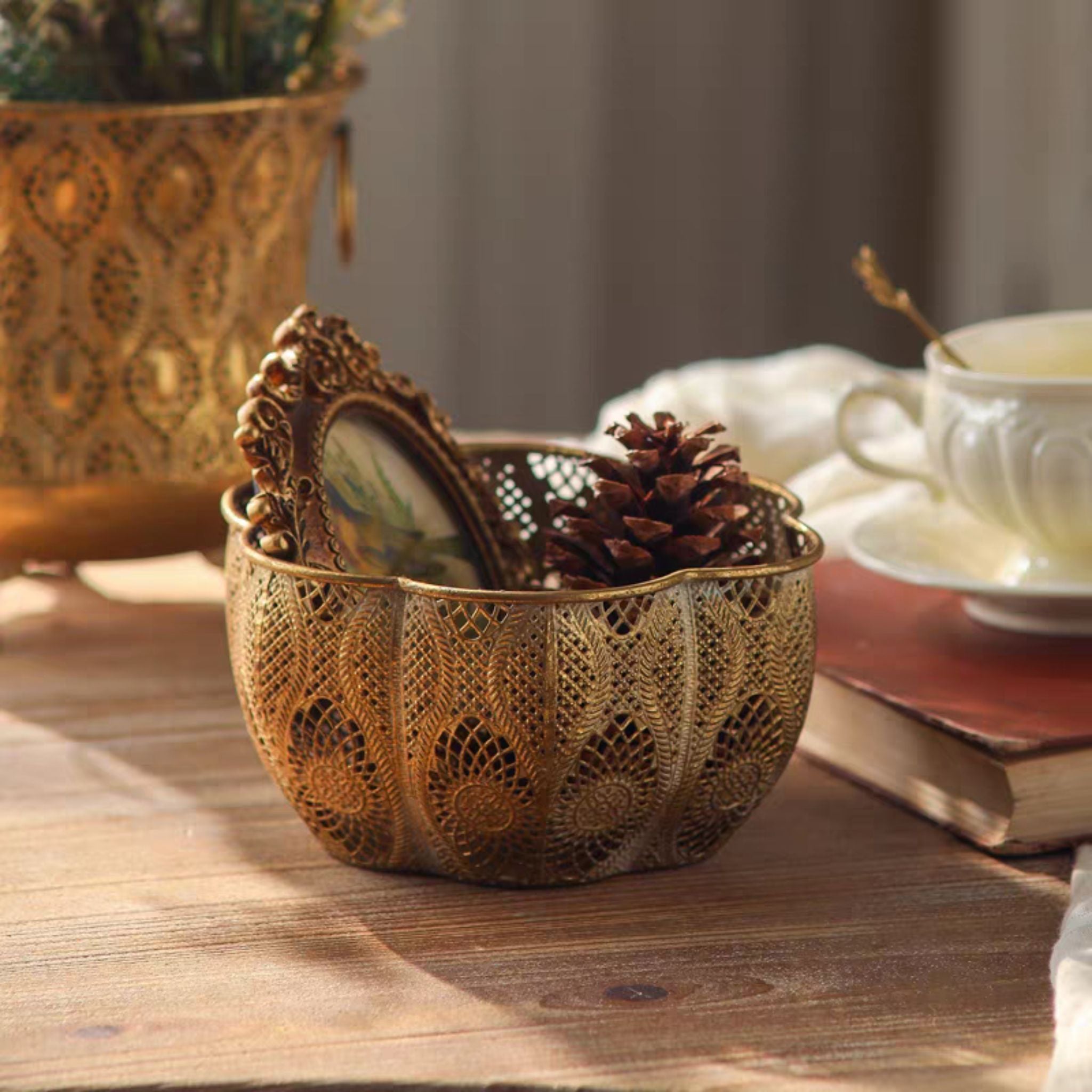 Rosalee bowl styled with pinecones on a table, pinecones and frame are not included