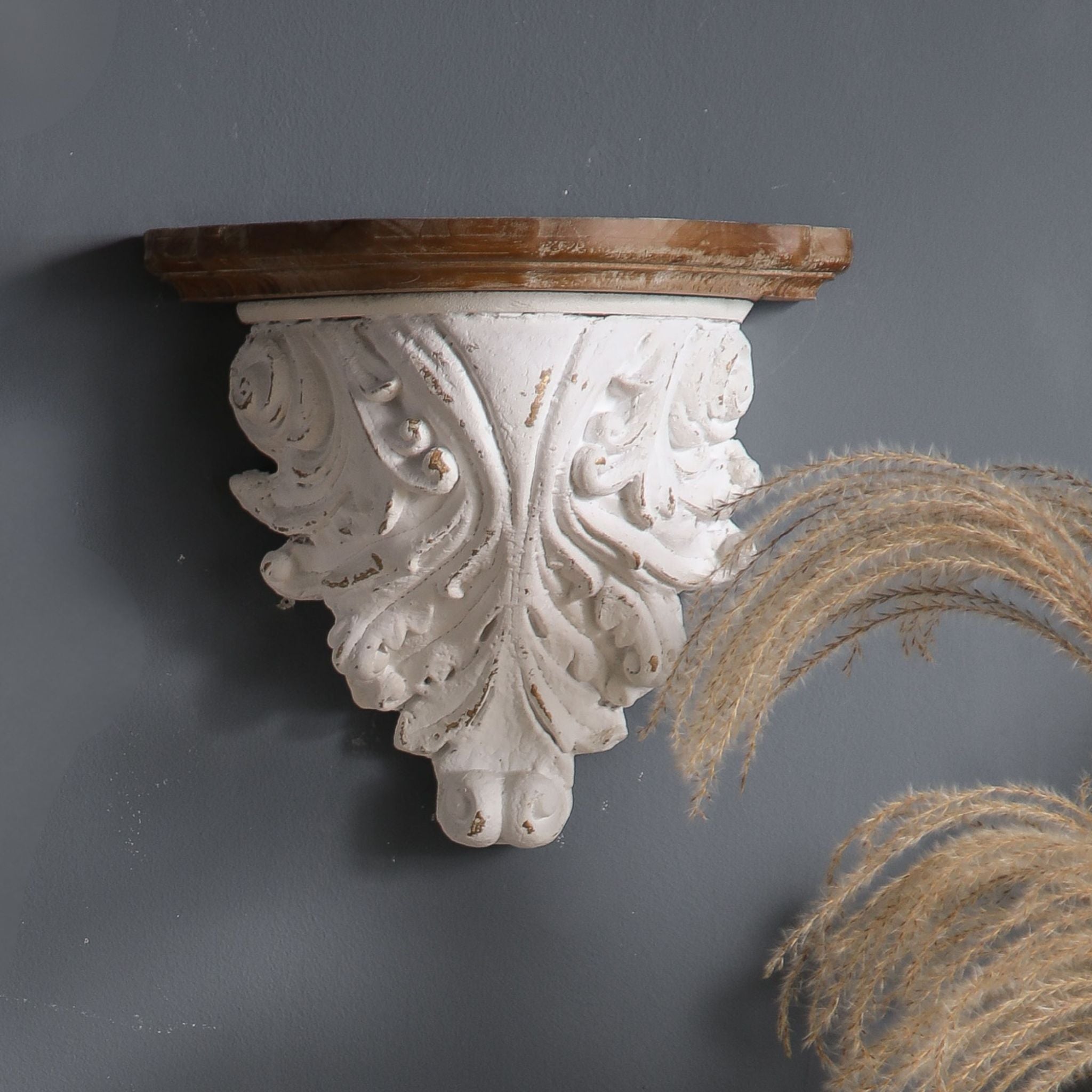 Rosalie French Provincial wall corbel shelf in distressed whitewash with carved acanthus leaves and warm timber top, hero close-up on a charcoal wall