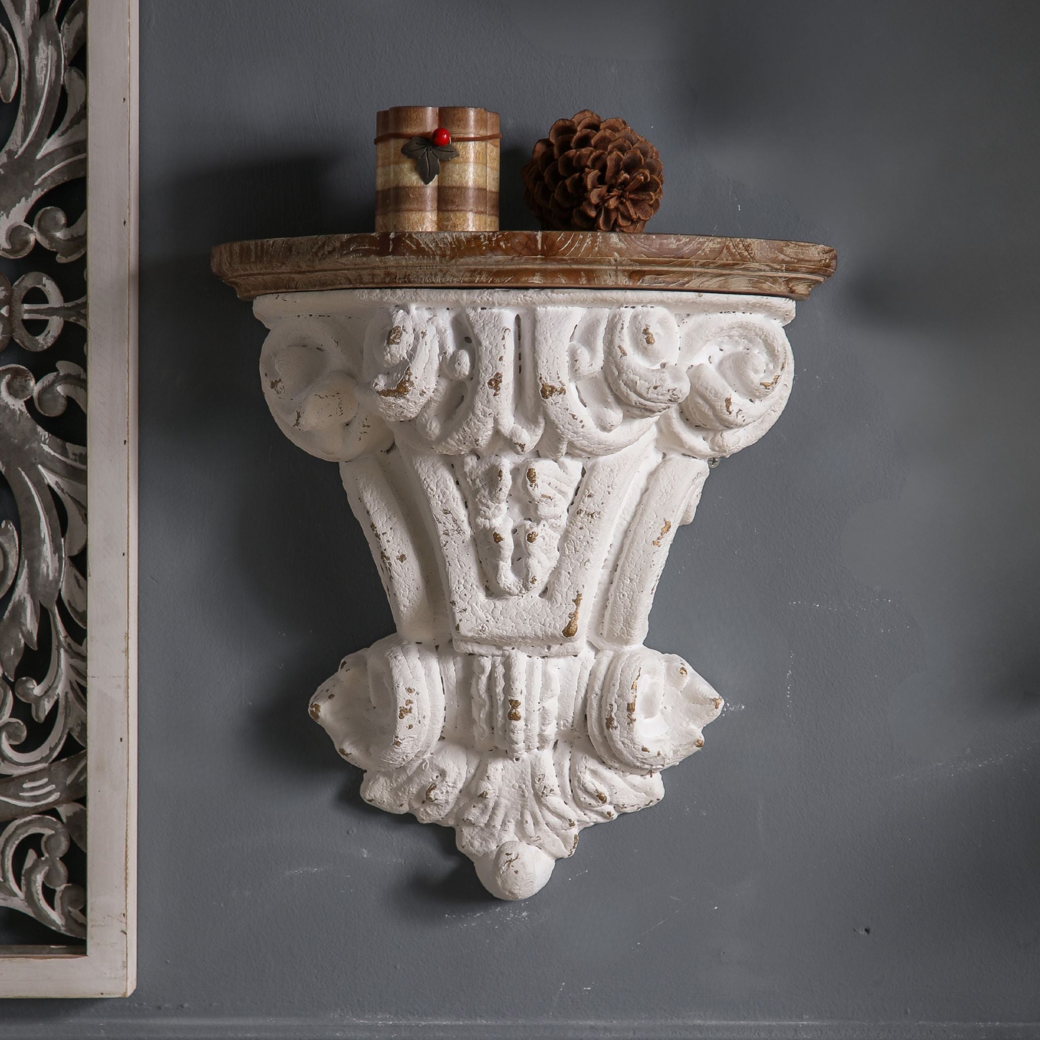 Séverine French Provincial wall corbel shelf in distressed whitewash with Corinthian capital carving and warm timber top, mounted solo on a charcoal wall. Hero