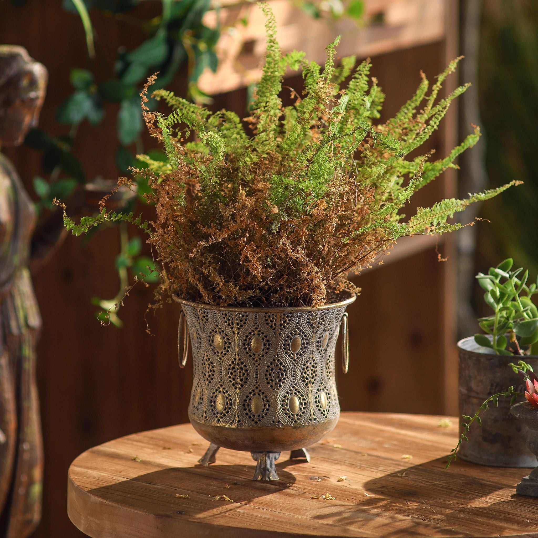 Seychelle French Provincial footed cachepot in pierced antique gold metal with a Moroccan-style filigree pattern. Hero.