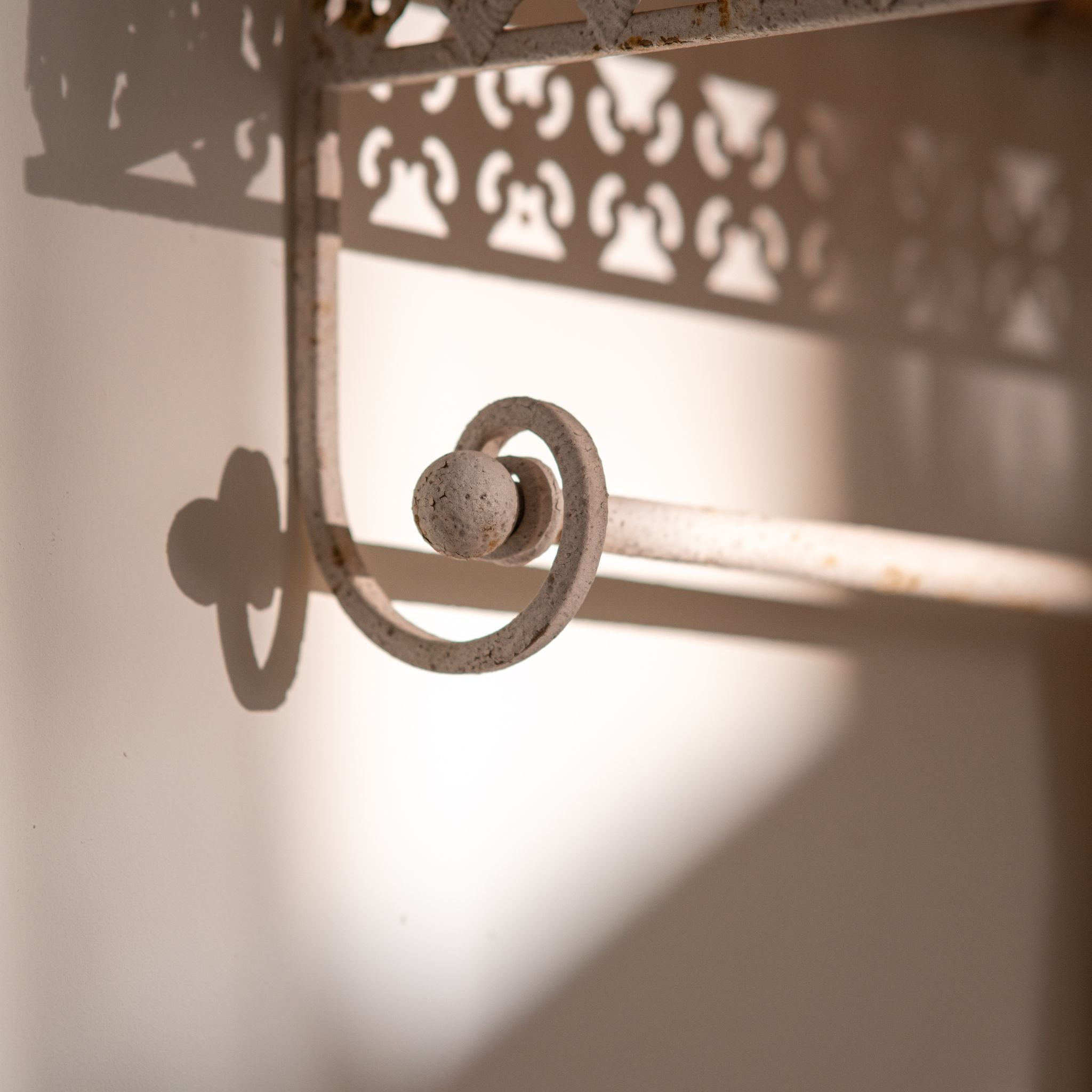 Simone wall shelf close-up of the scroll bracket and rail end