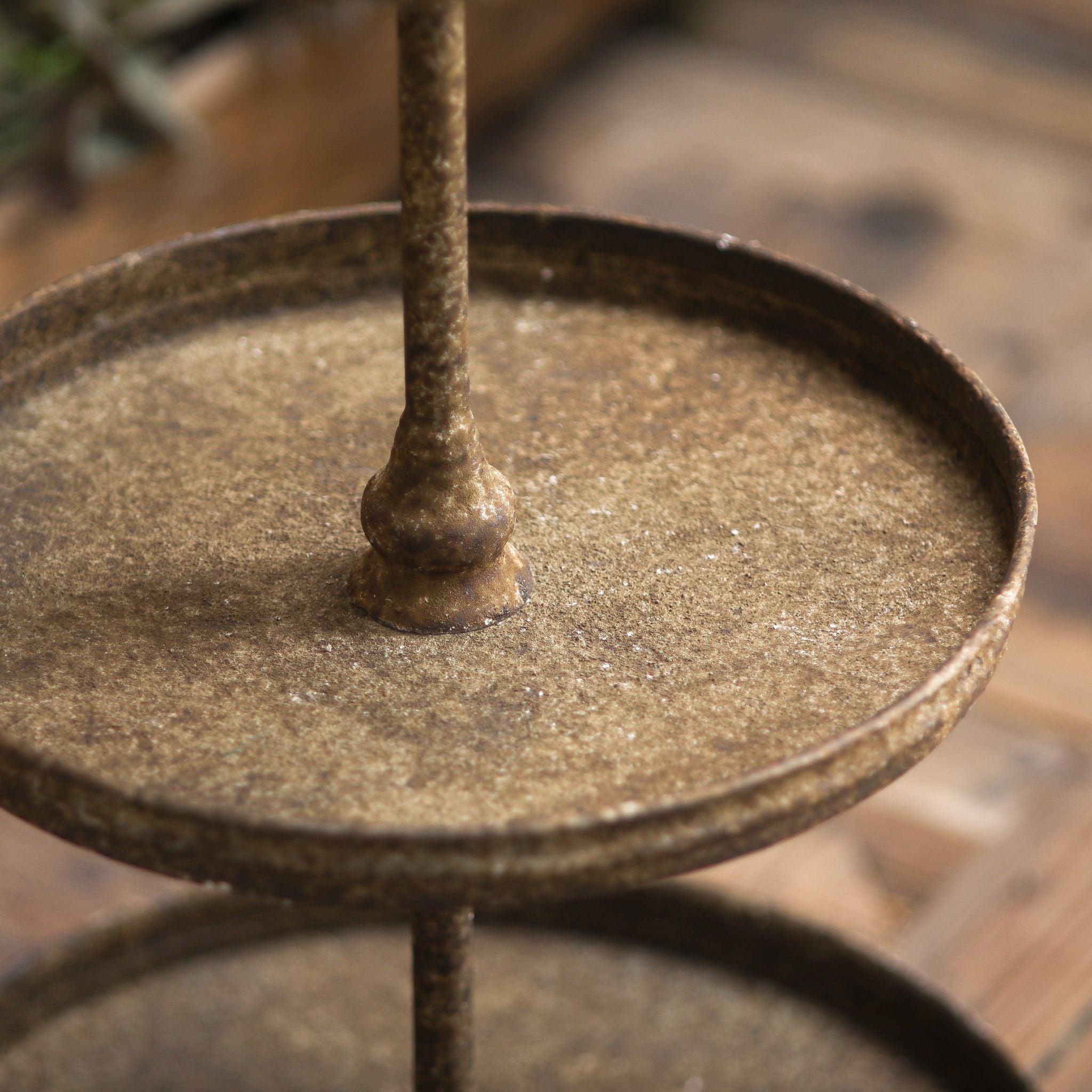 Close detail of a Timéo tray and the turned pole joint, showing the distressed rust-brown texture