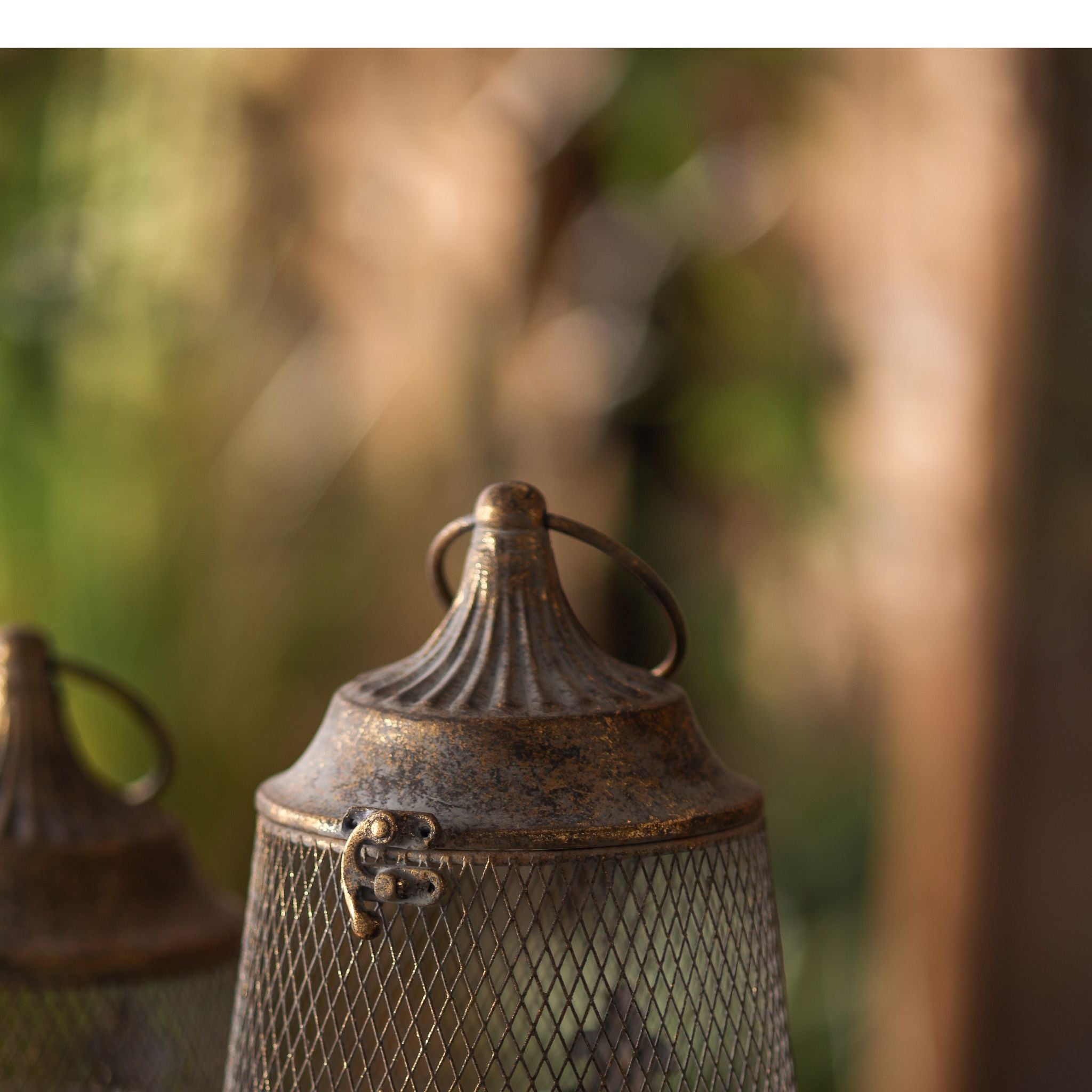 Detail of Sophie candle lantern fluted domed top, ring handle and scroll clasp in aged gold metal