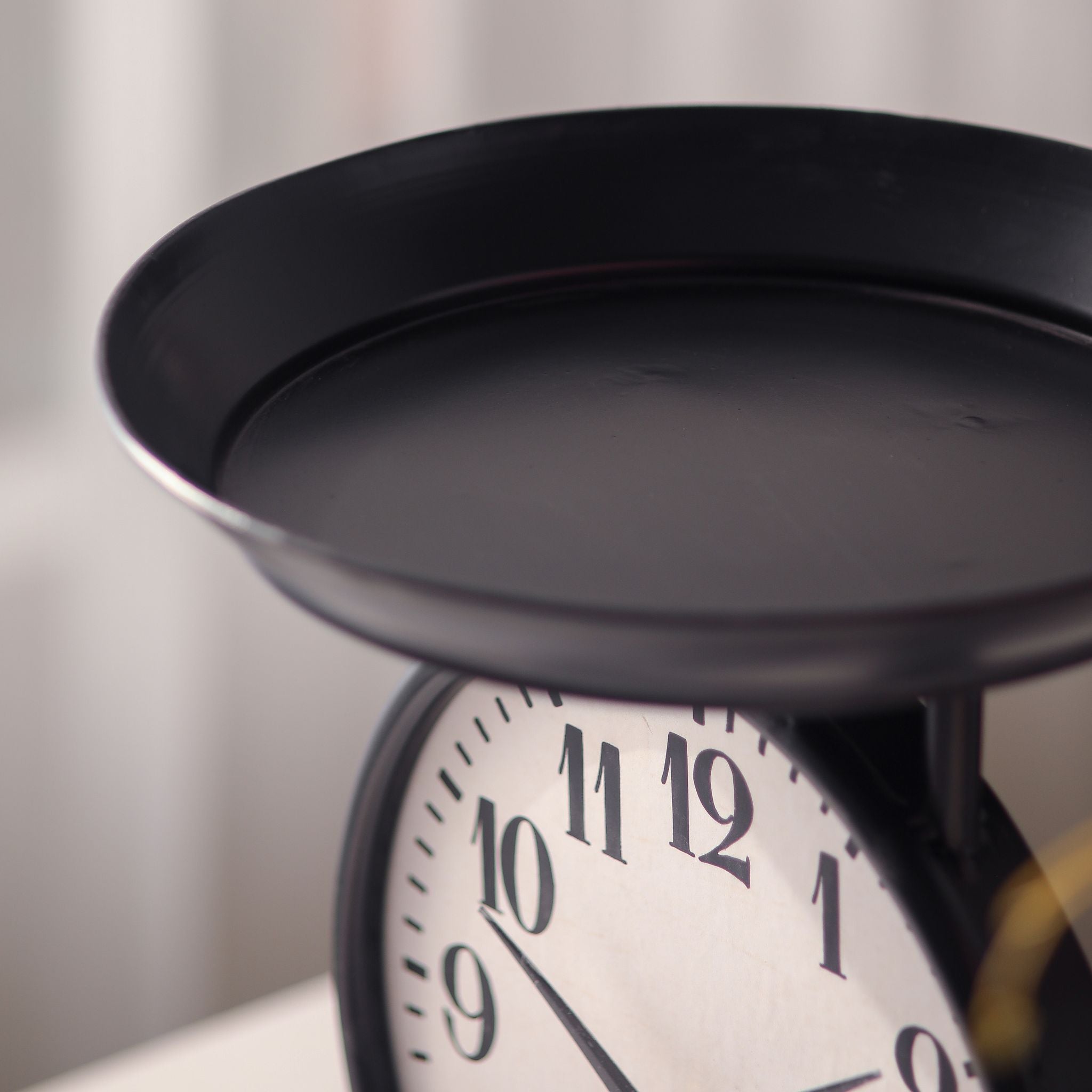 Detail of the Patricia clock's black metal display tray on top