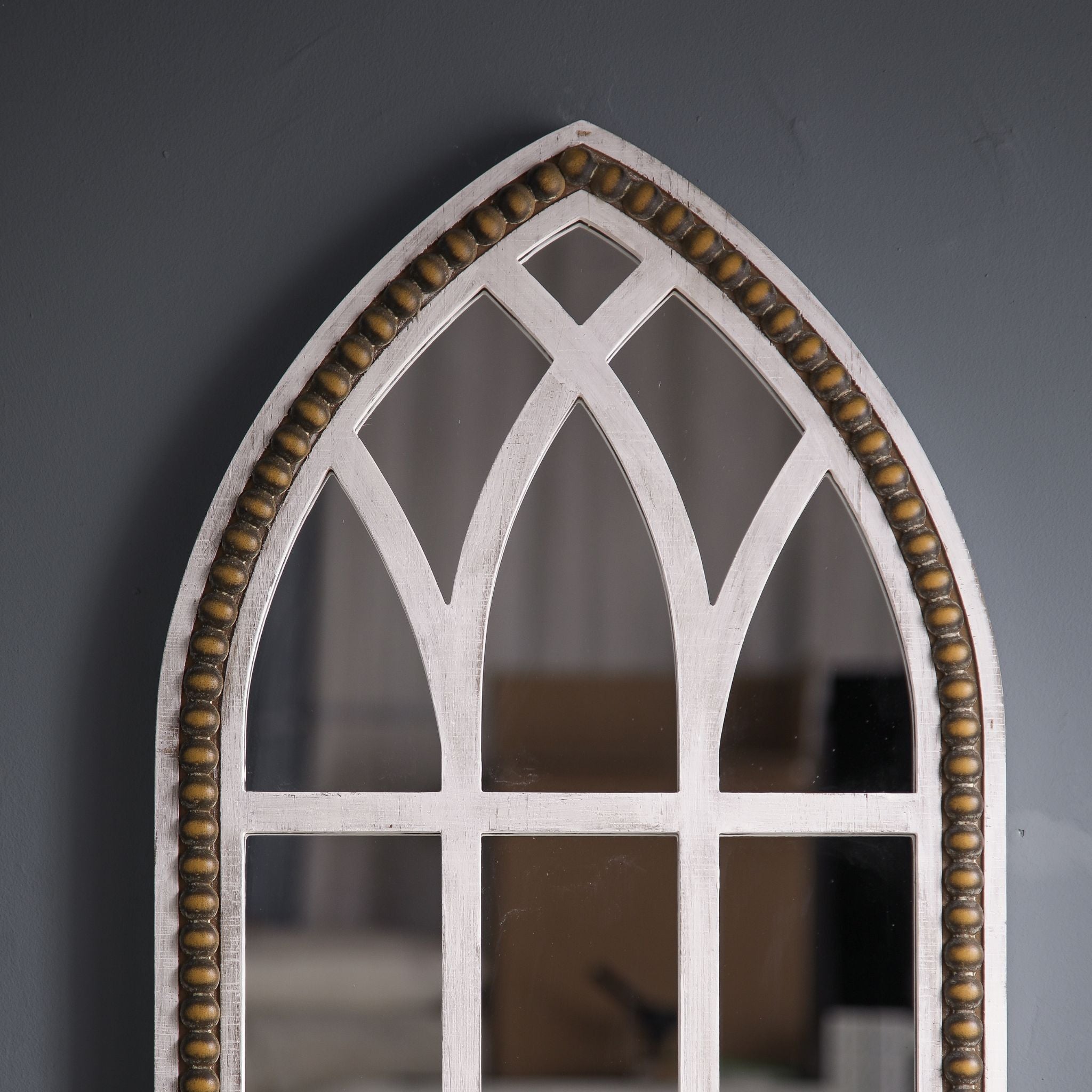 Close-up of Vincent's Gothic lancet arch crown showing the beaded trim and tracery mullions in whitewashed fir