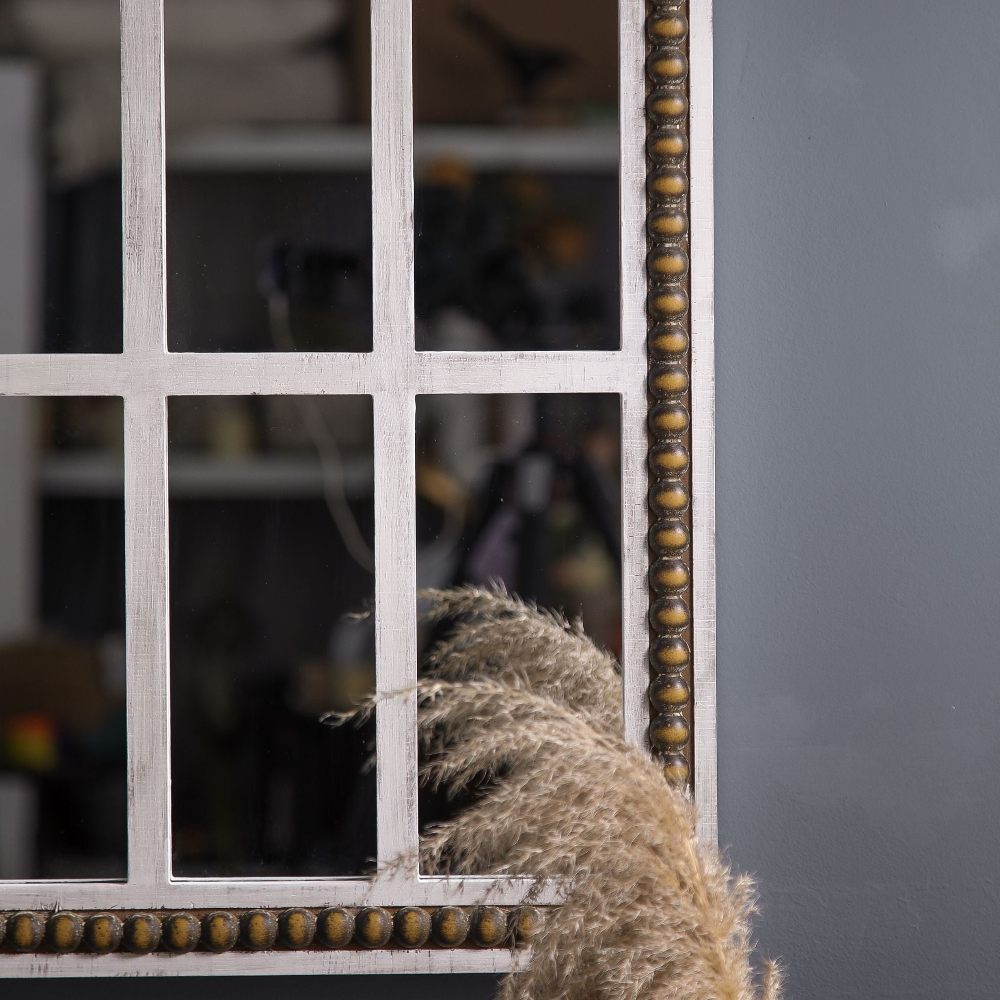 Detail of the lower frame corner showing the whitewashed fir, twelve-pane window mullions and bronze-gilt bead-and-reel trim