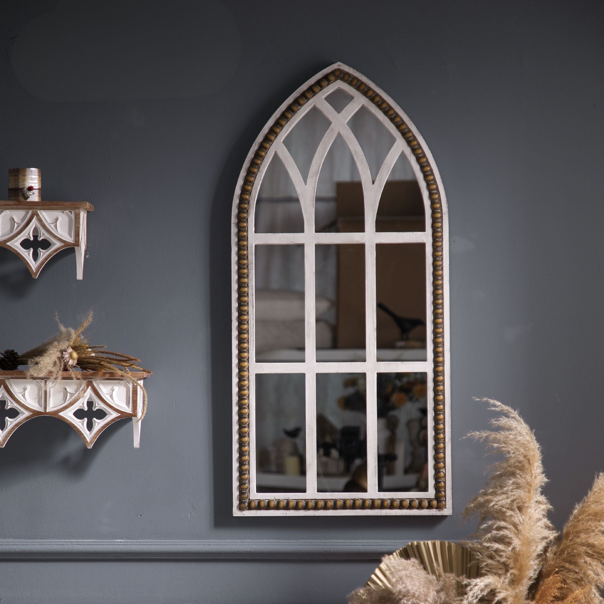 Vincent Gothic arch window mirror styled on a French Provincial grey wall beside fluted wall sconces with pampas grass.