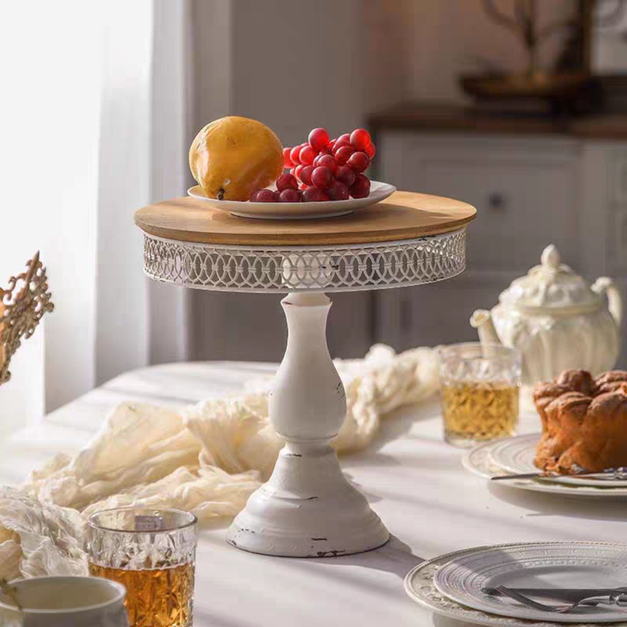 Violette cake stand styled on a dressed table with cake and tea.