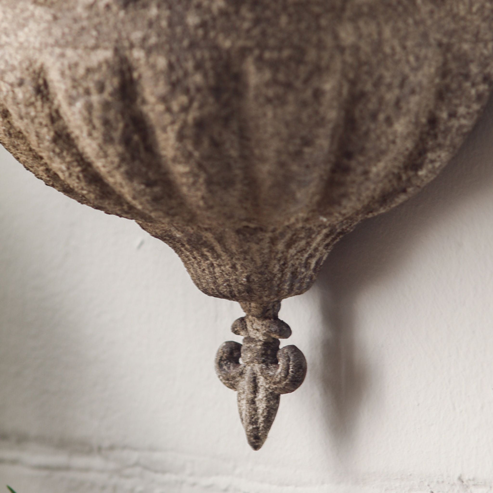 Close-up of the fluted bowl and fleur-de-lis drop on the Claire wall planter