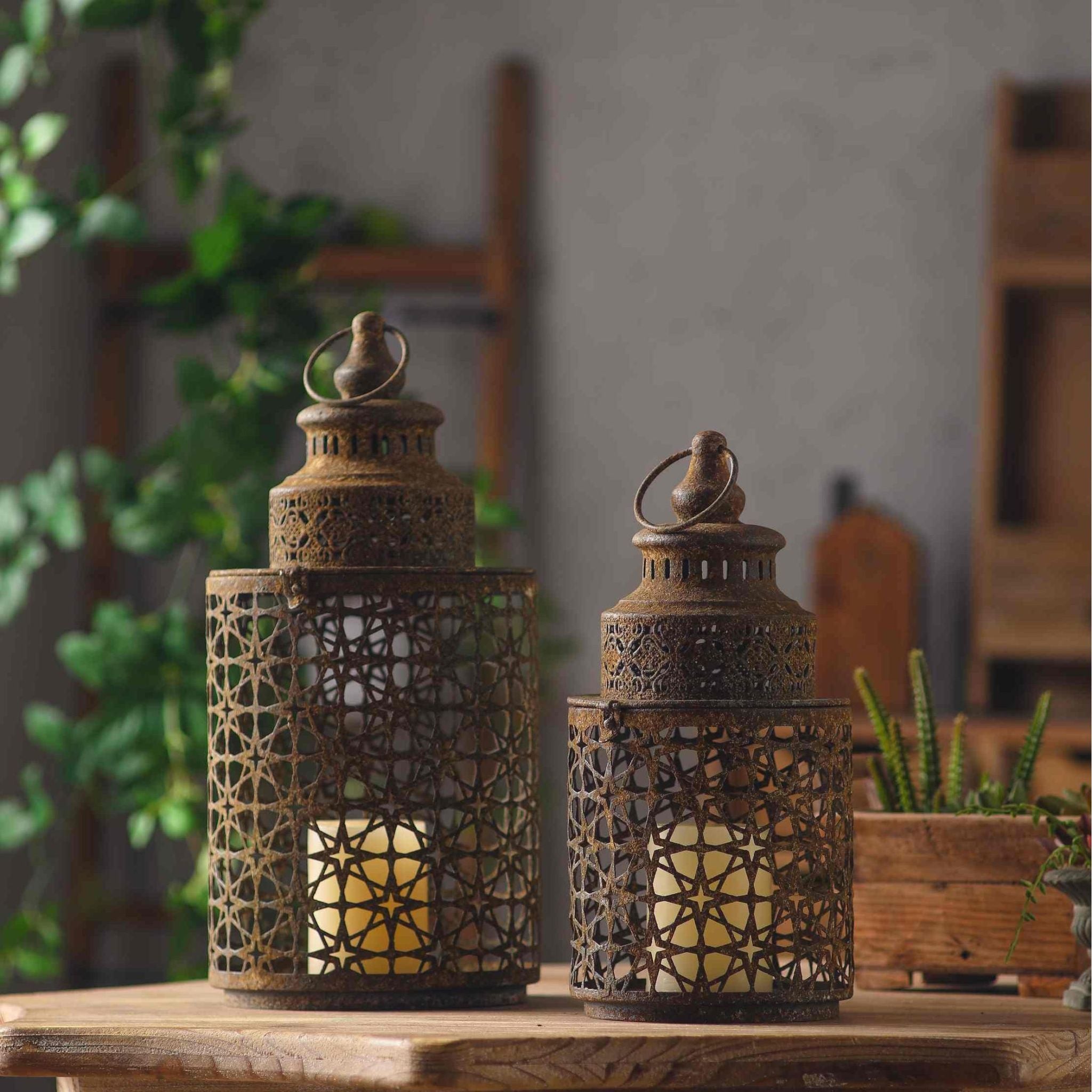 Yannick and the smaller Rueben star lanterns together on a timber table, styled with potted succulents.